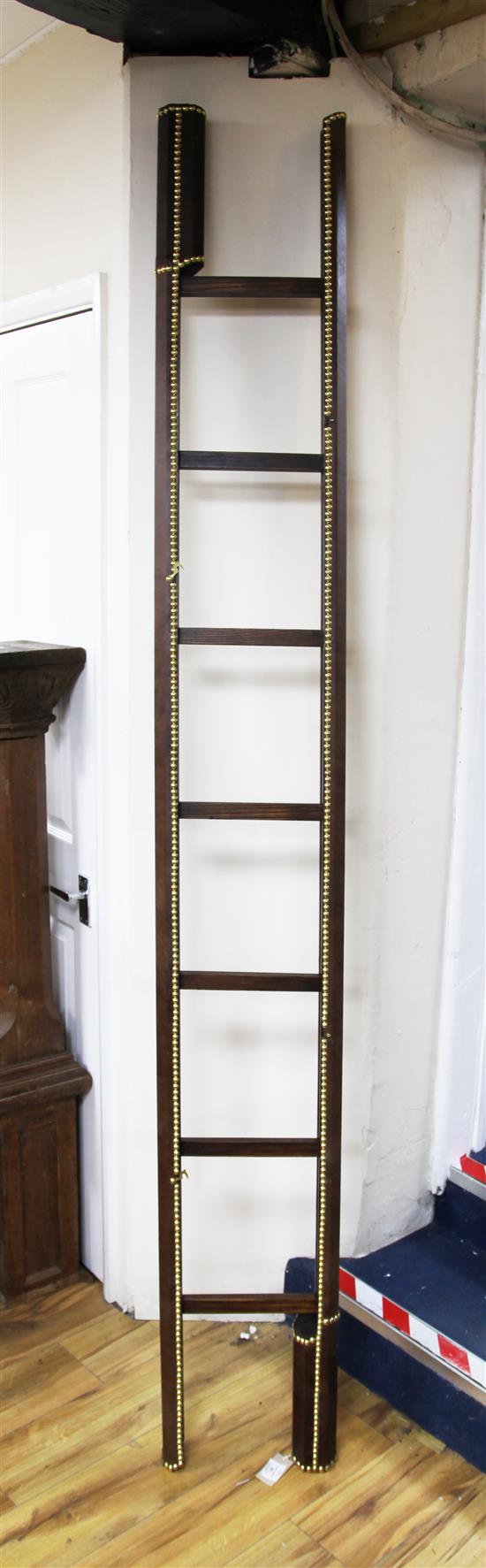 A leather and brass studded folding library ladder,